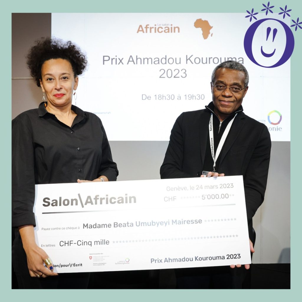 Beata Umubyeyi Mairesse receives her award from Romuald Fonkoua. Photo/Pierre Albouy