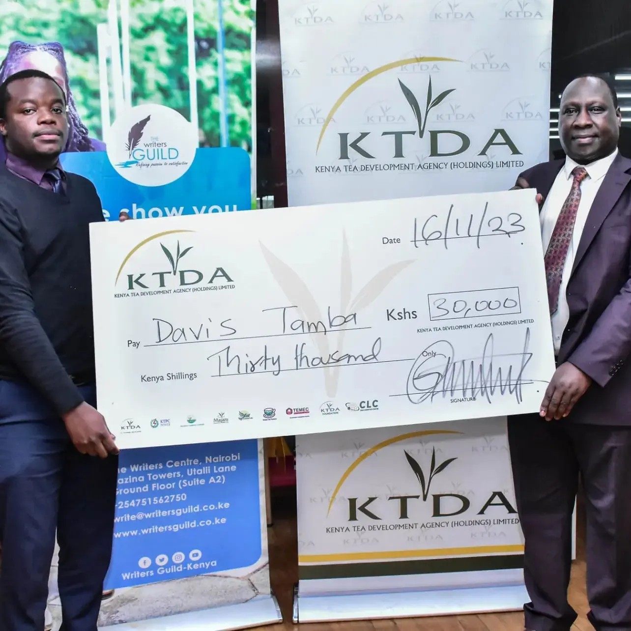 Davis Tamba receives his award from KTDA CEO Wilson Muthaura