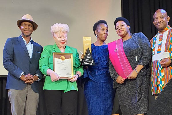 Terry Ann Adams (second from left) receives her award.
